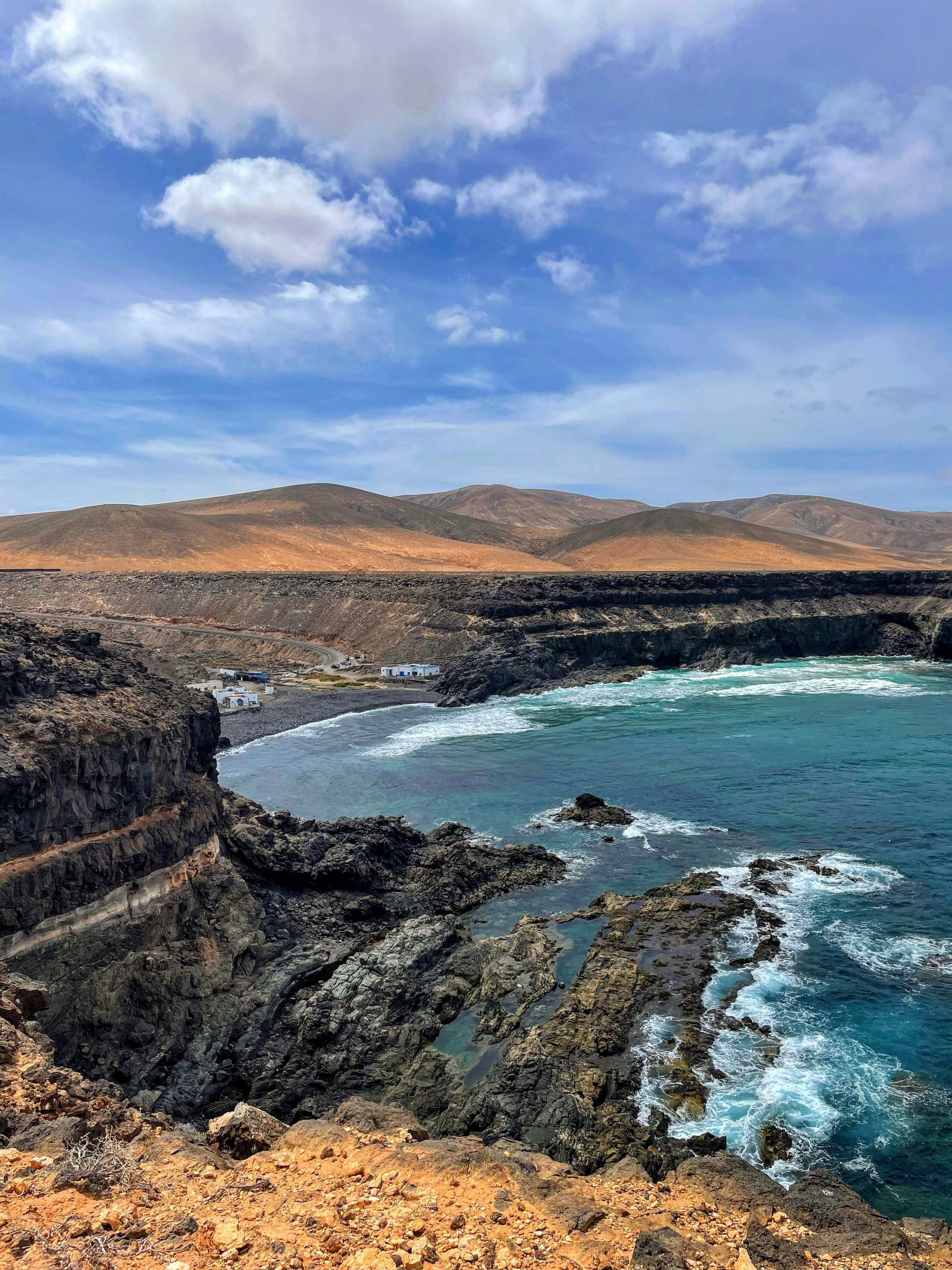 Panoramic view of Sotavento beach with golden sand peninsula curving into a turquoise lagoon and distant mountains