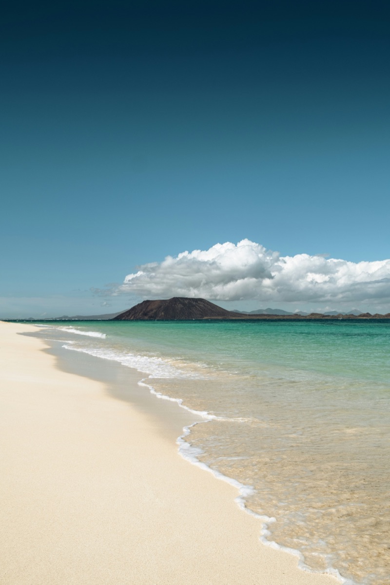 Sandy beach with Isla de Lobos in the distance